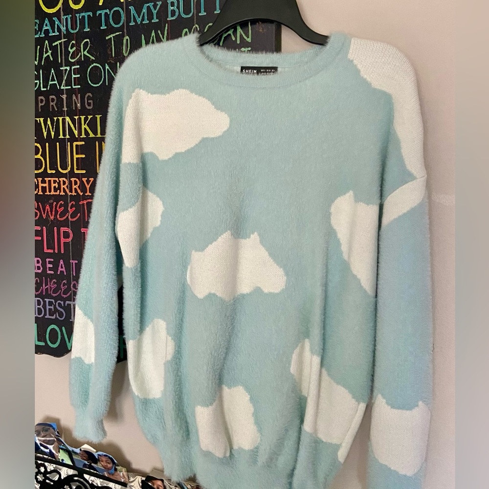 Blue sweater with cloud detailing